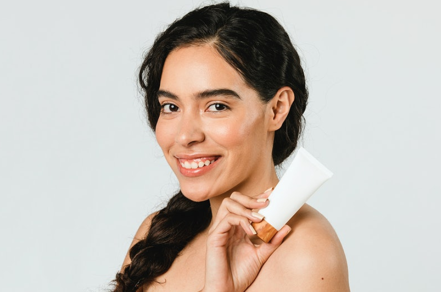 woman holding skin care products